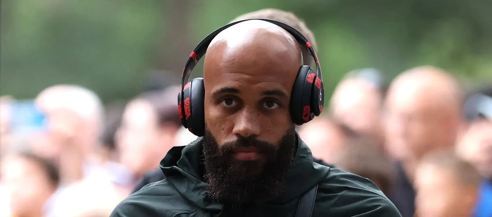 Player wearing headphones walking through crowd Player wearing headphones walking through crowd