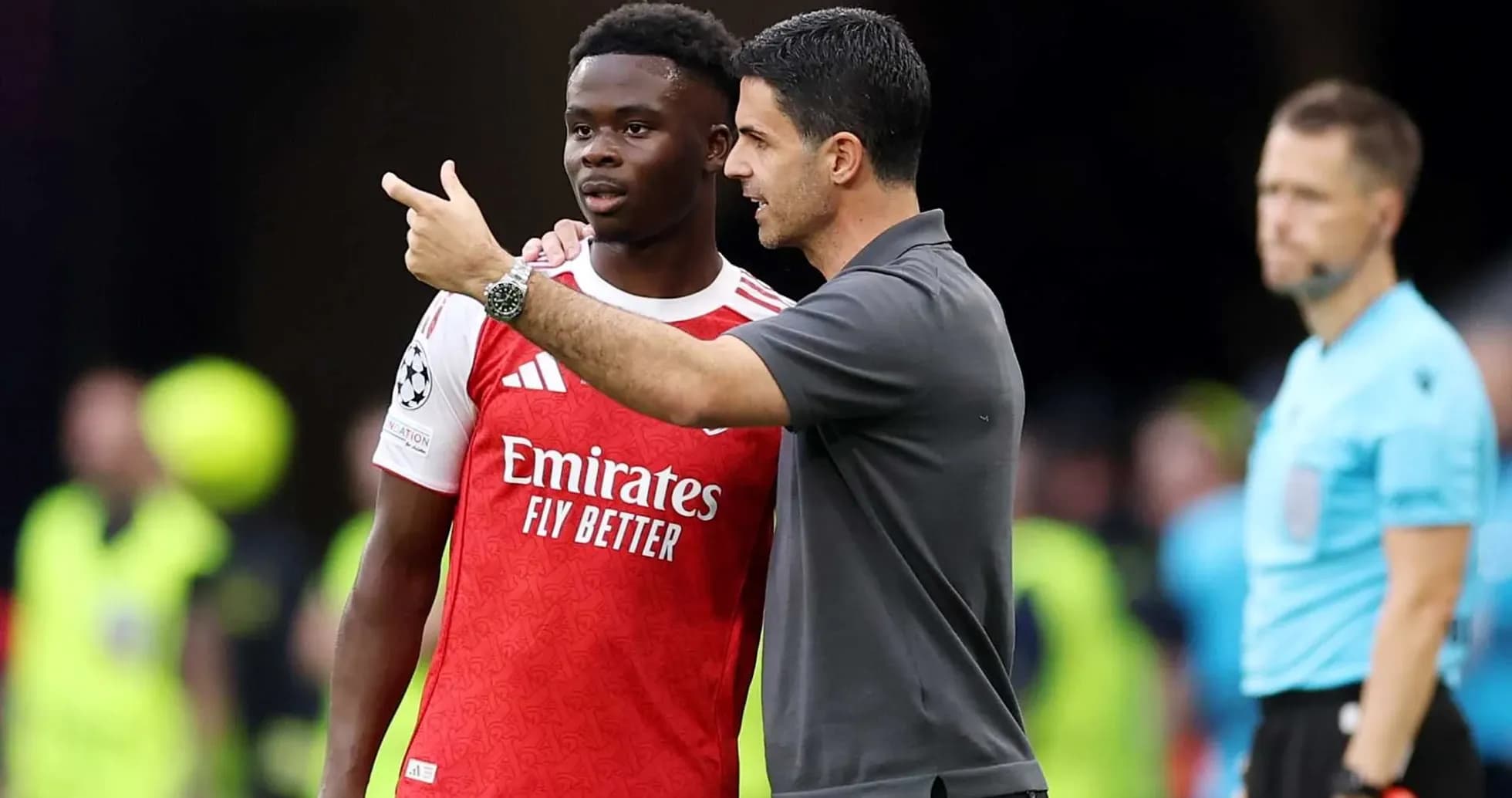 Manager speaking to player during match on sidelines Manager speaking to player during match on sidelines
