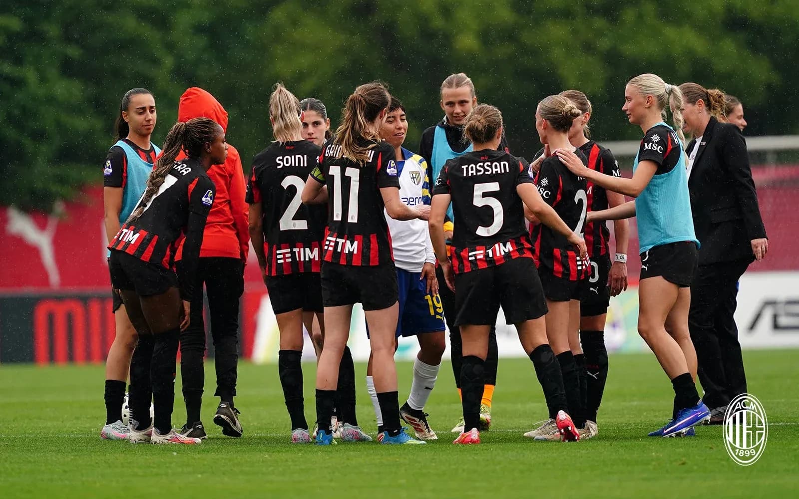 AC Milan women team discussing strategy on field AC Milan women team discussing strategy on field
