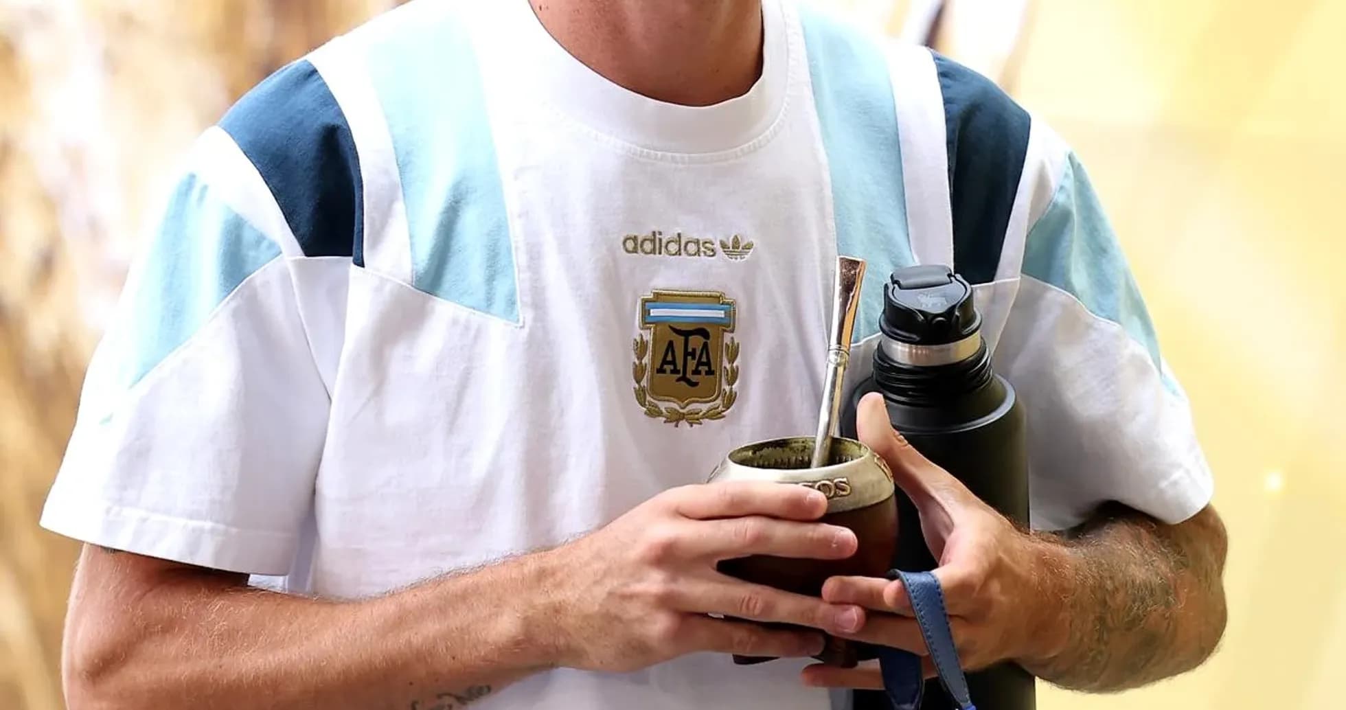 Player holding mate cup and water bottle Player holding mate cup and water bottle