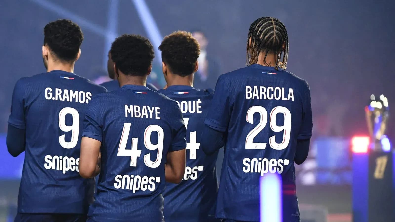 Players from team wearing blue jerseys with numbers Players from team wearing blue jerseys with numbers