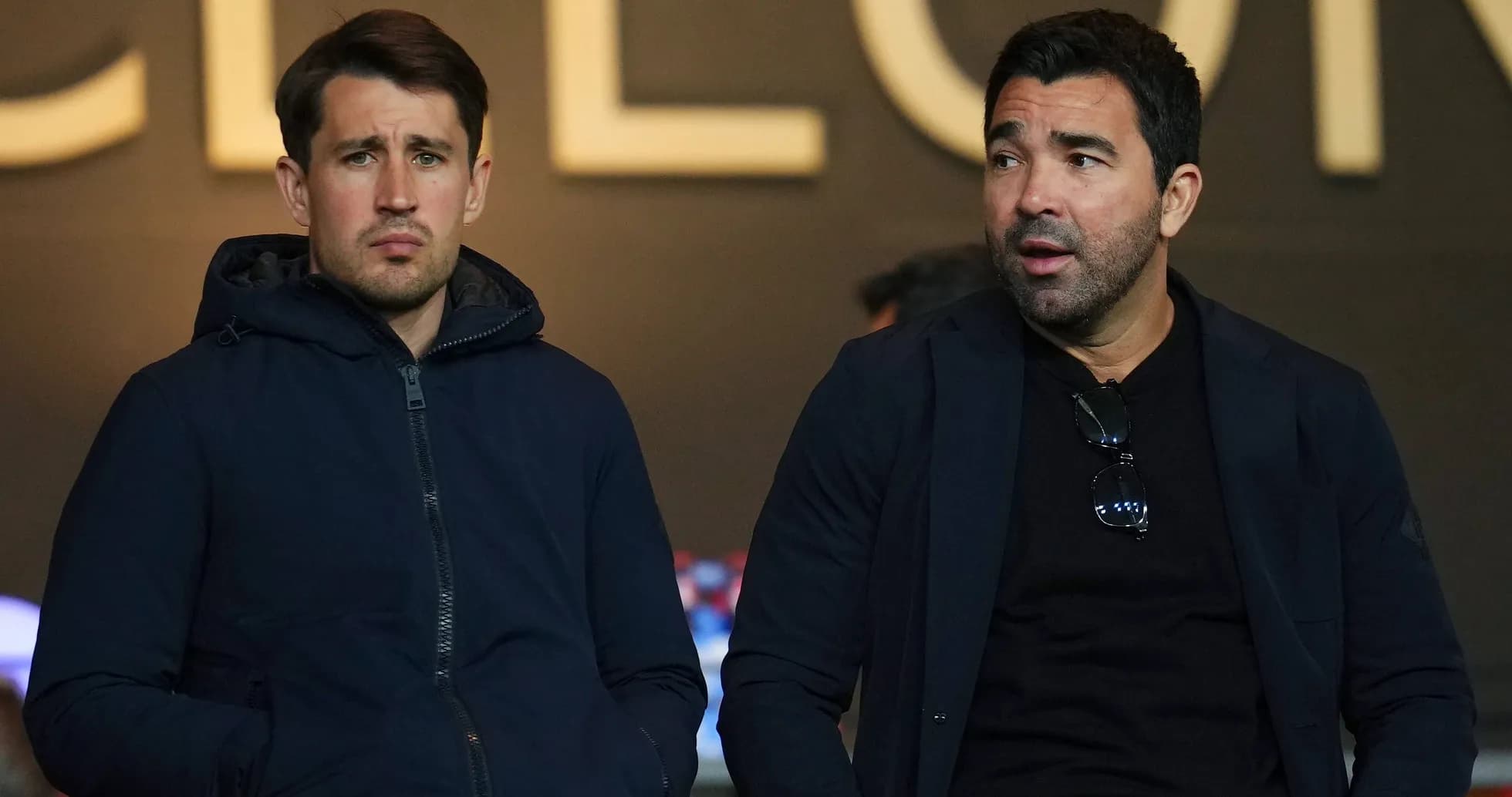 Two men sitting together in a stadium Two men sitting together in a stadium