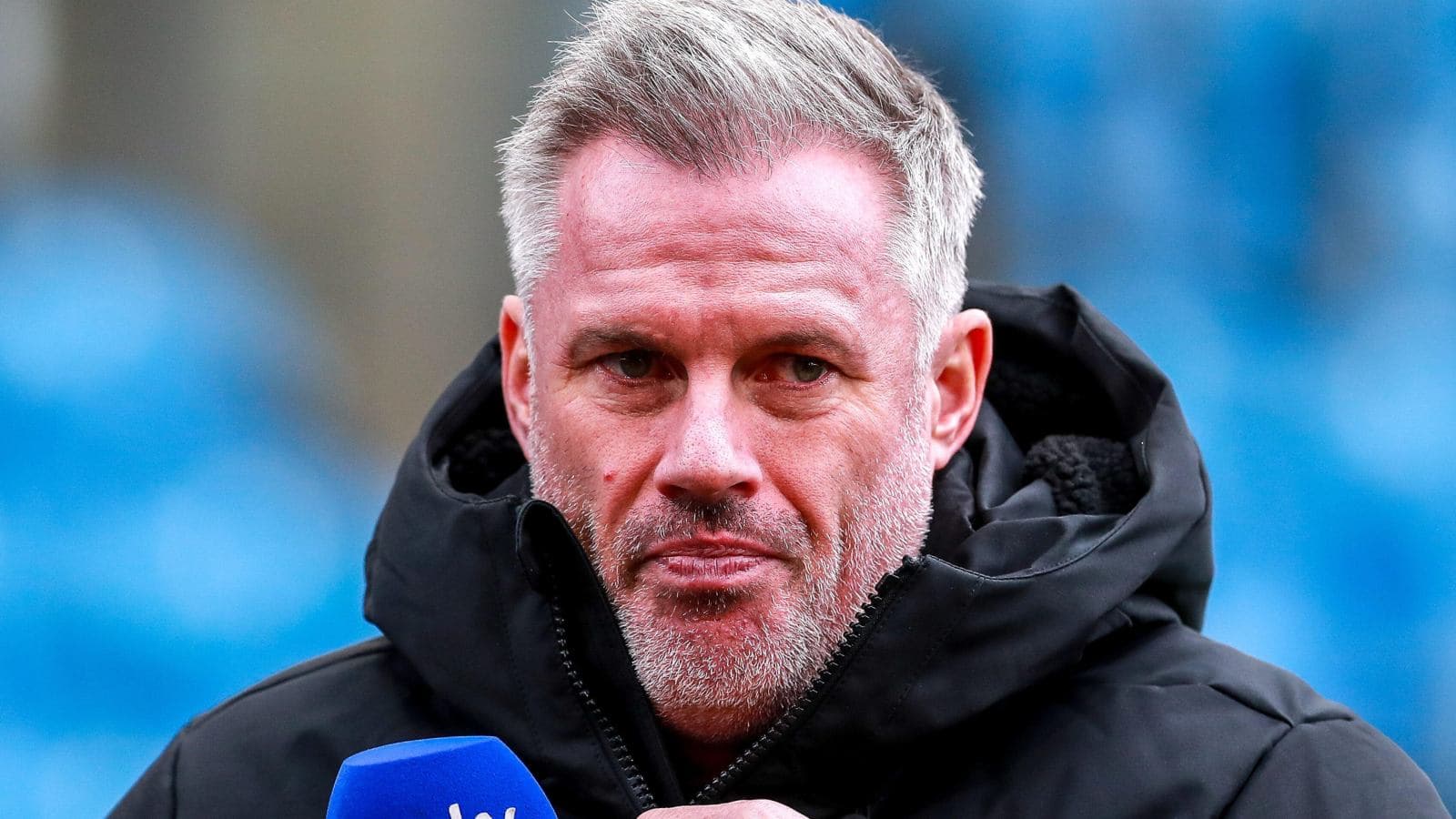 Sports analyst speaking into microphone on field Sports analyst speaking into microphone on field