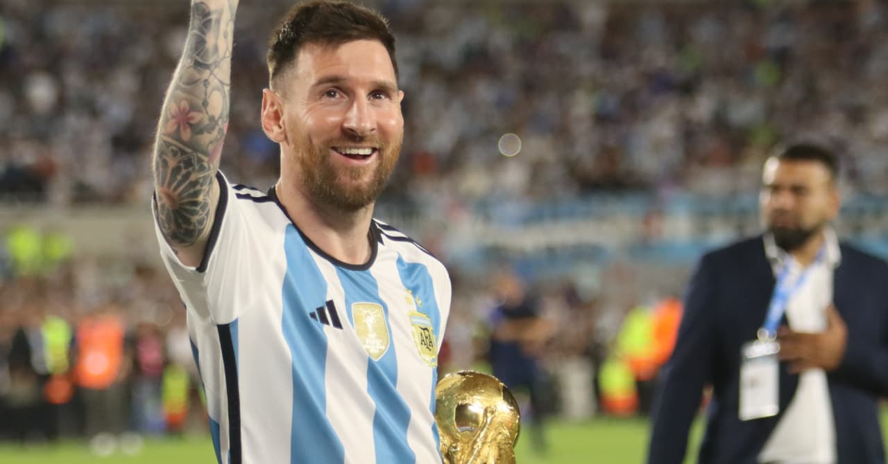 Player celebrating with trophy in stadium Player celebrating with trophy in stadium