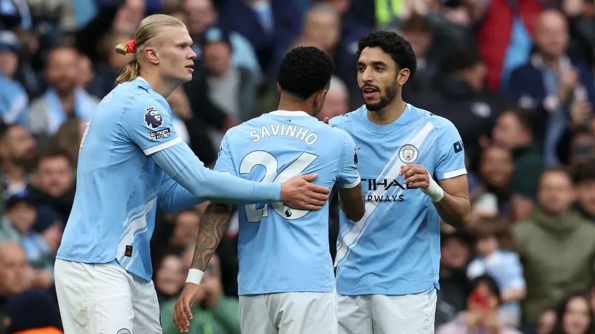 Manchester City players celebrating together on the field Manchester City players celebrating together on the field