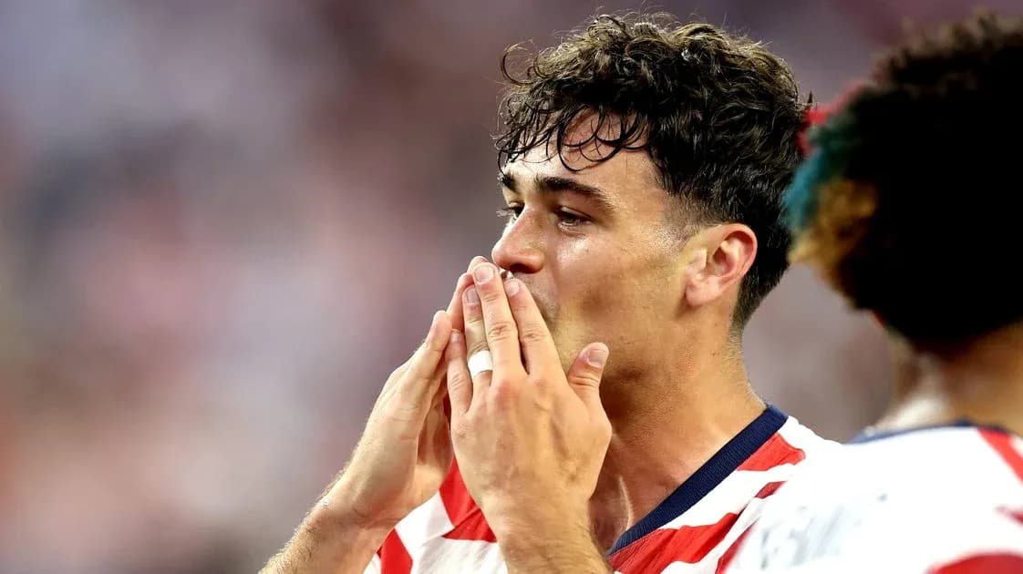 Player celebrating with hands to mouth during match Player celebrating with hands to mouth during match