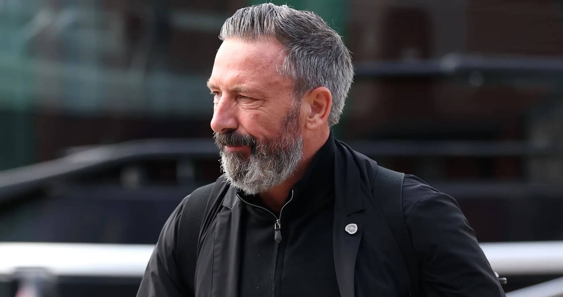 Man with gray beard walking in casual attire Man with gray beard walking in casual attire