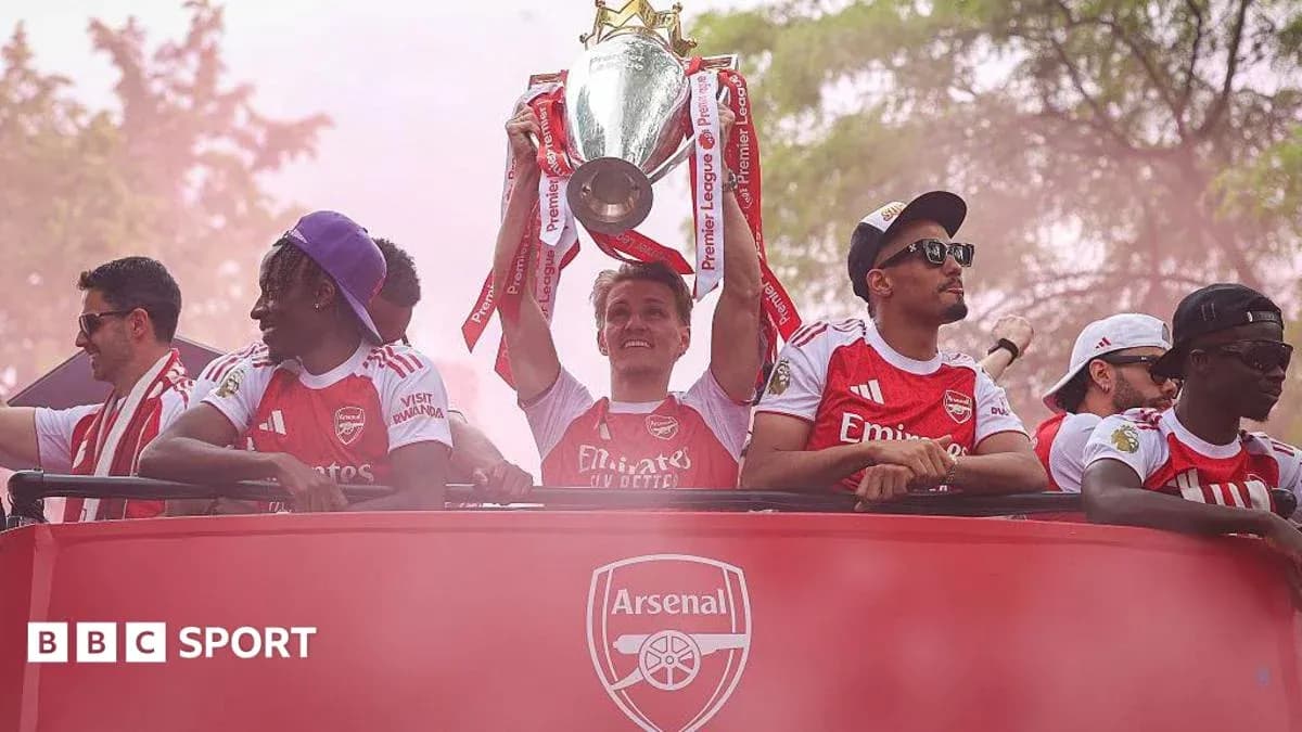 Arsenal players celebrating with the Premier League trophy Arsenal players celebrating with the Premier League trophy