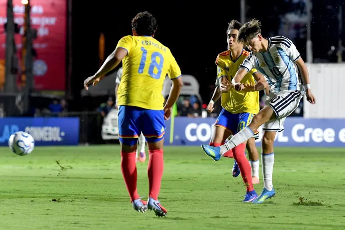 Argentinian player kicking ball past two defenders Argentinian player kicking ball past two defenders