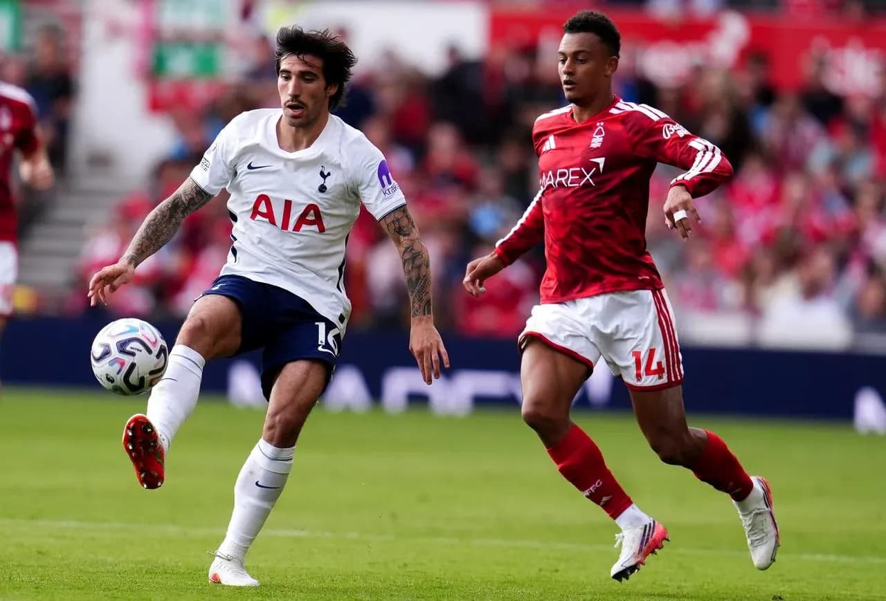 Tottenham player kicking the ball against Nottingham Tottenham player kicking the ball against Nottingham