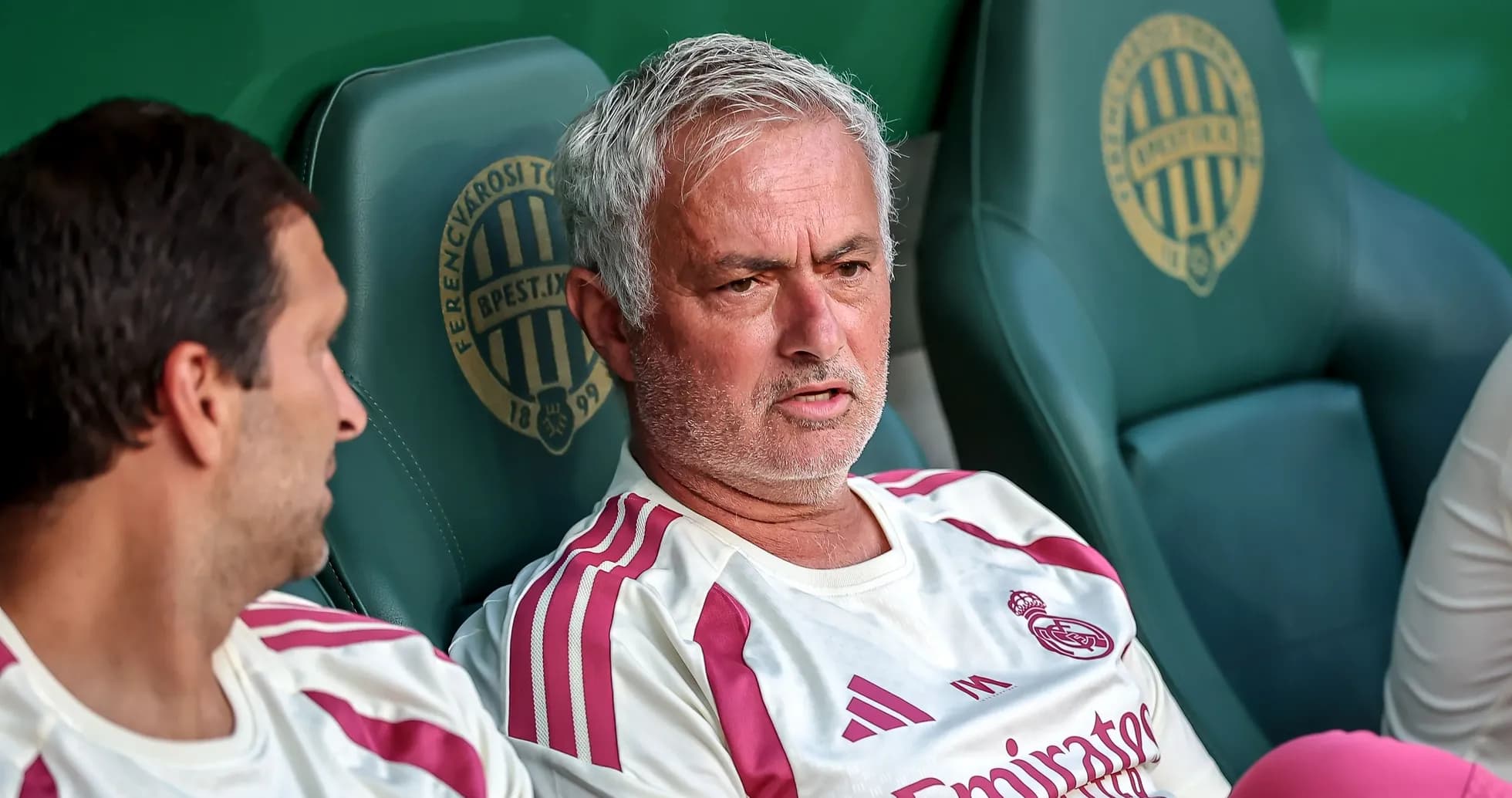 Manager discussing strategy on the bench during match Manager discussing strategy on the bench during match