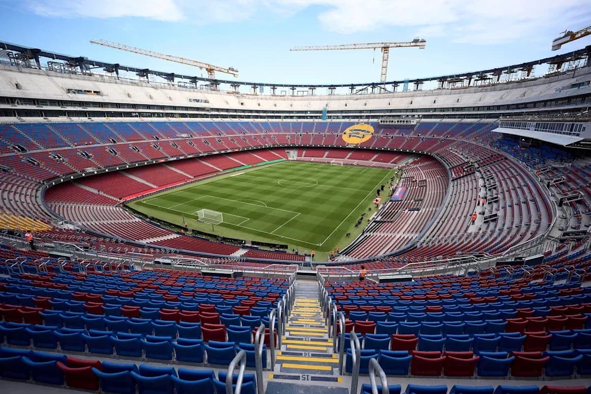 View of empty stadium with green pitch and stands View of empty stadium with green pitch and stands