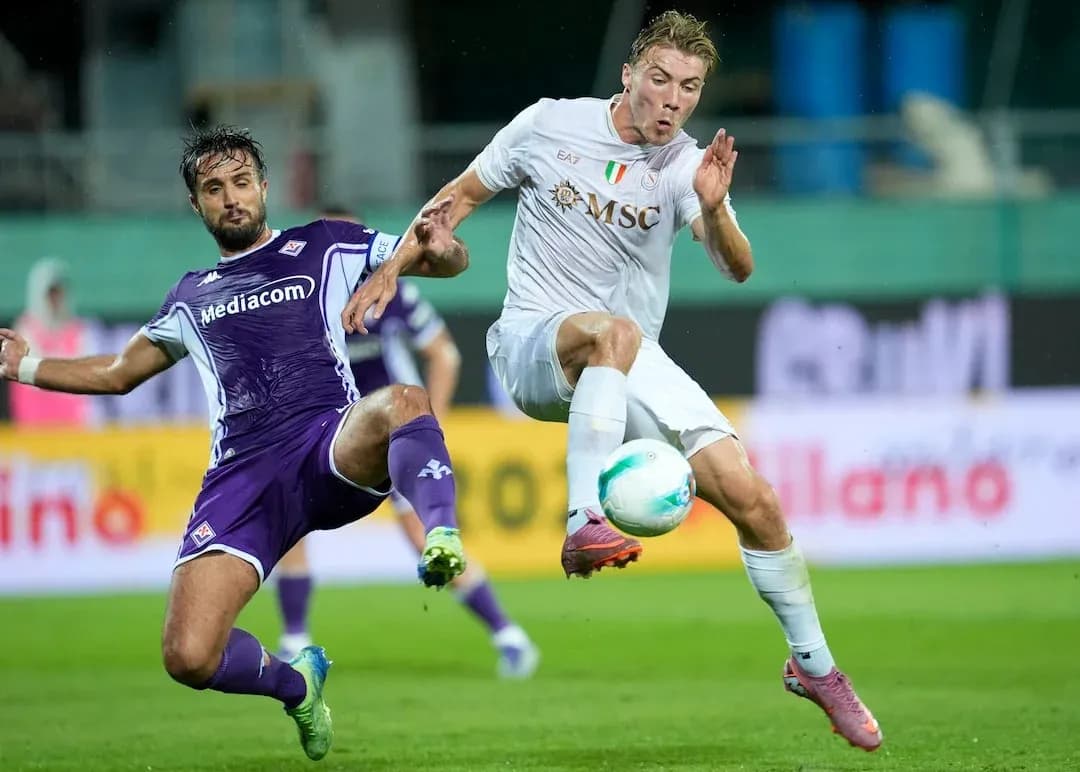 Fiorentina player tackles Napoli opponent during match Fiorentina player tackles Napoli opponent during match