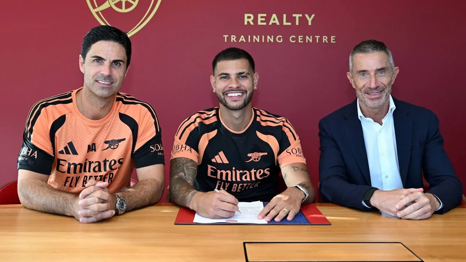 Player signing contract with club officials at training center Player signing contract with club officials at training center