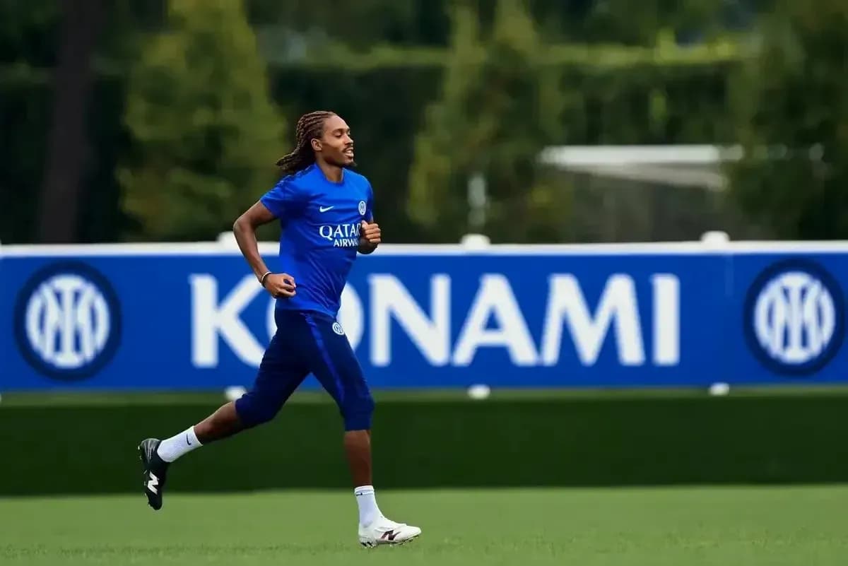 Player jogging on training pitch with team branding Player jogging on training pitch with team branding