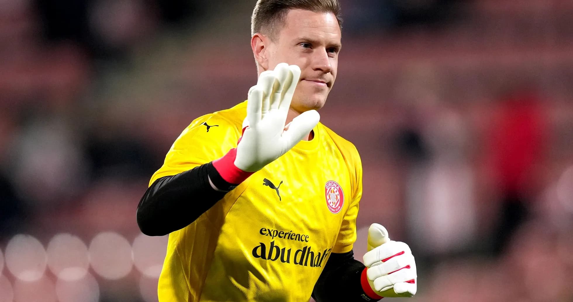 Goalkeeper waving in yellow jersey during warm-up Goalkeeper waving in yellow jersey during warm-up