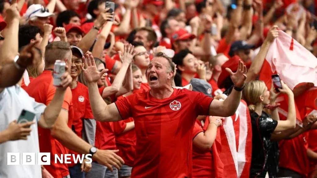 Fans celebrating in red attire at a sports event Fans celebrating in red attire at a sports event