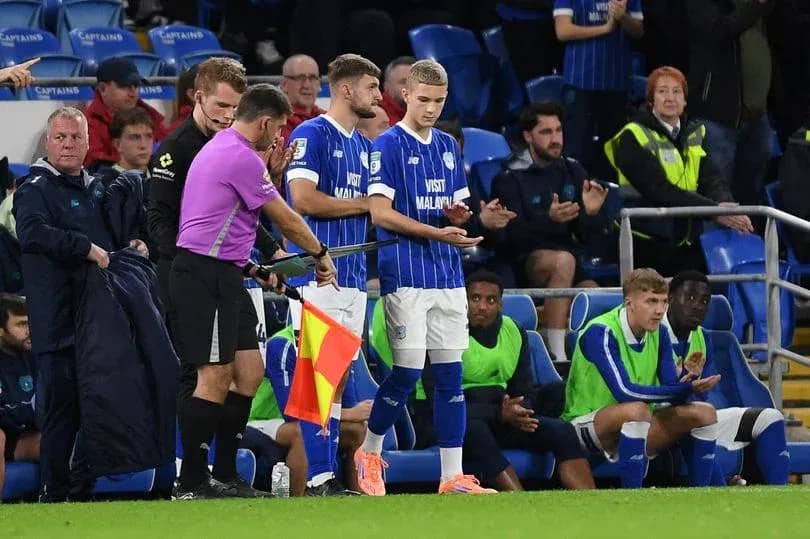 Player being substituted during football match Player being substituted during football match