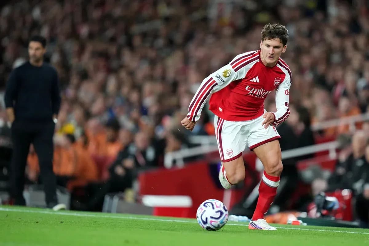 Arsenal player running with ball during match Arsenal player running with ball during match