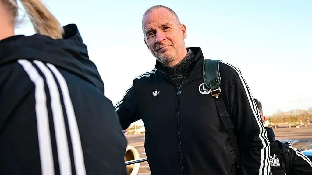 Coach wearing black tracksuit at airport Coach wearing black tracksuit at airport
