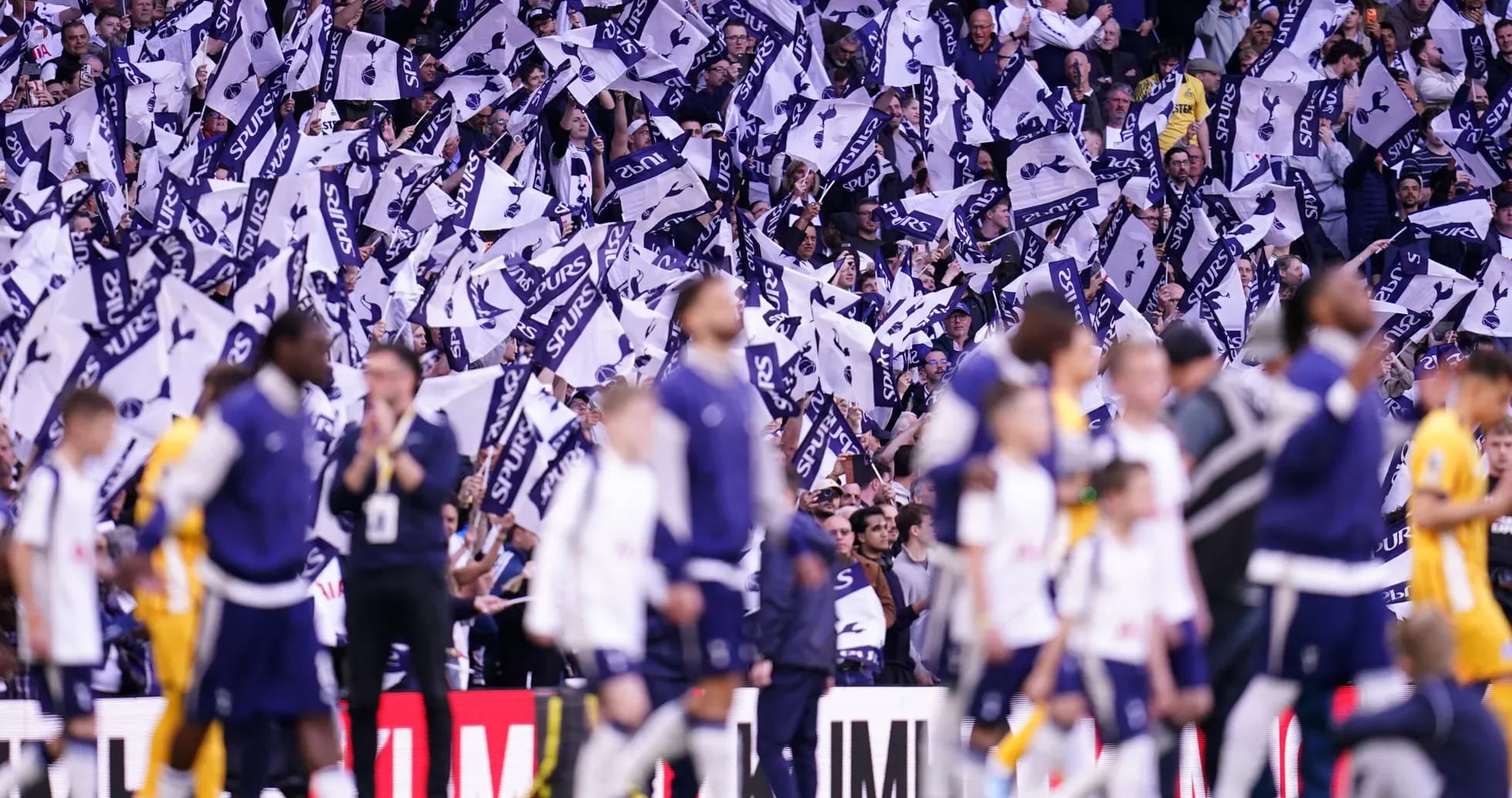 Fans waving Spurs flags during match celebration Fans waving Spurs flags during match celebration