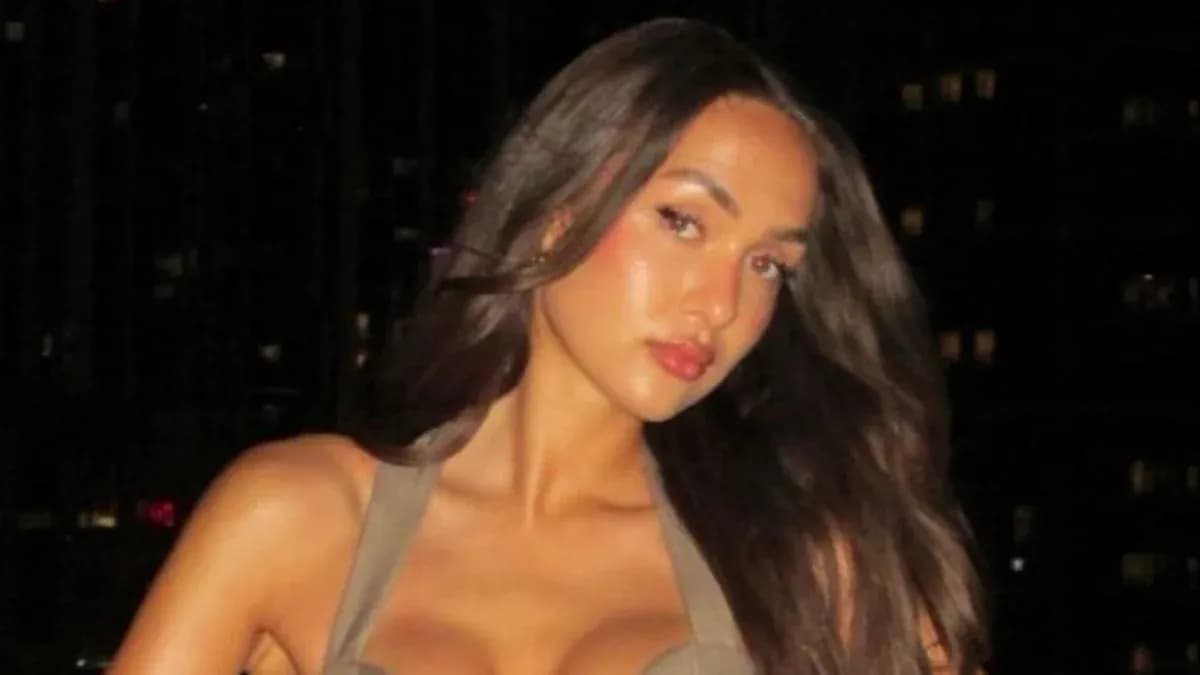 Person posing with long hair against a dark background Person posing with long hair against a dark background