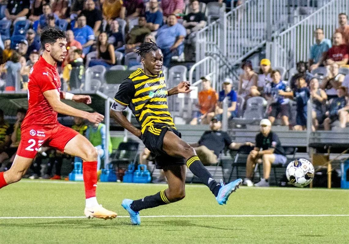 Player kicking ball during Pittsburgh Riverhounds match Player kicking ball during Pittsburgh Riverhounds match