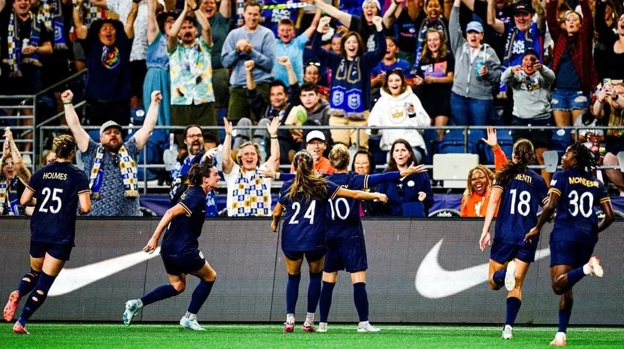 Seattle Reign FC celebrating a goal with fans Seattle Reign FC celebrating a goal with fans
