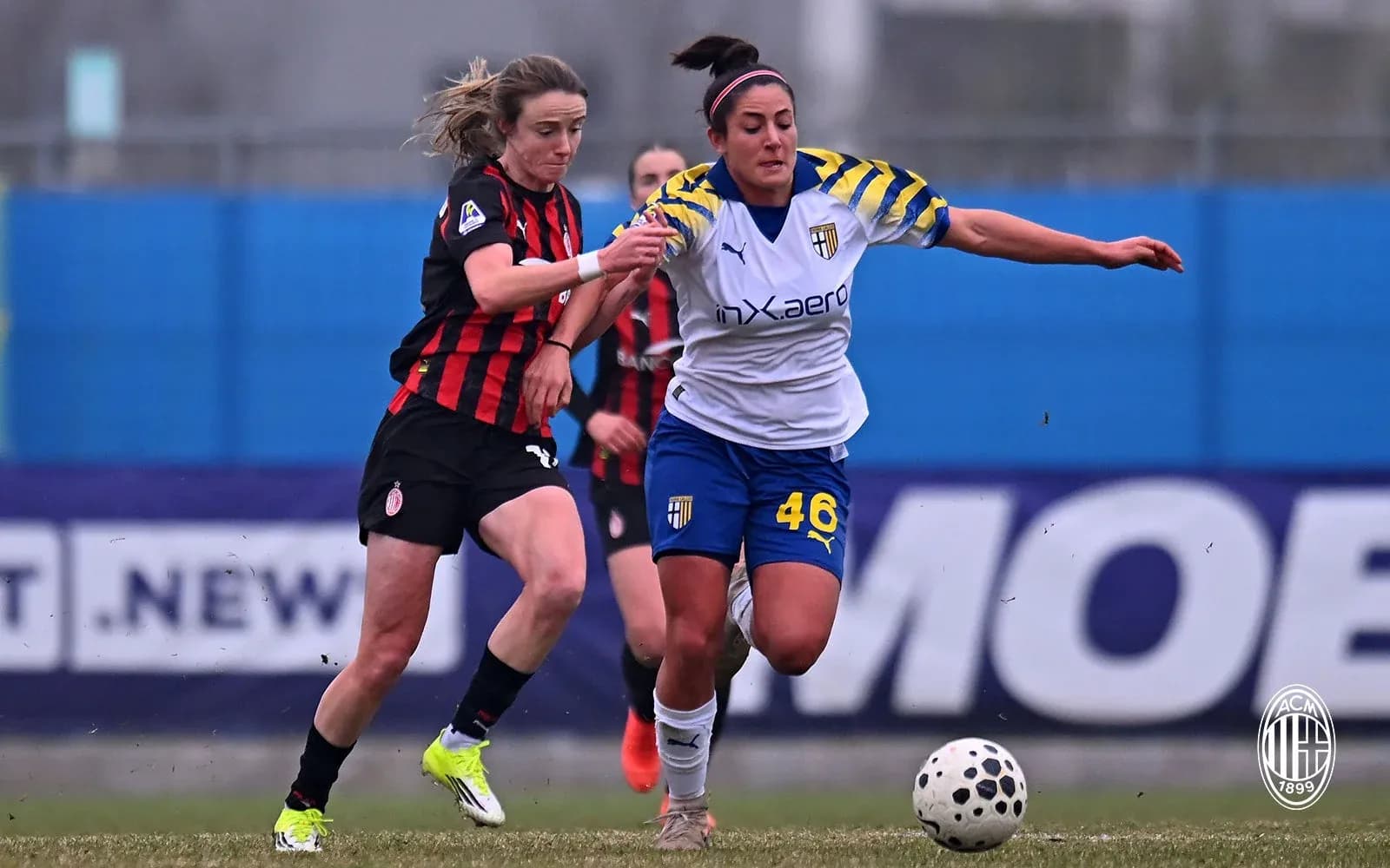 AC Milan W player challenges Parma W player for ball AC Milan W player challenges Parma W player for ball