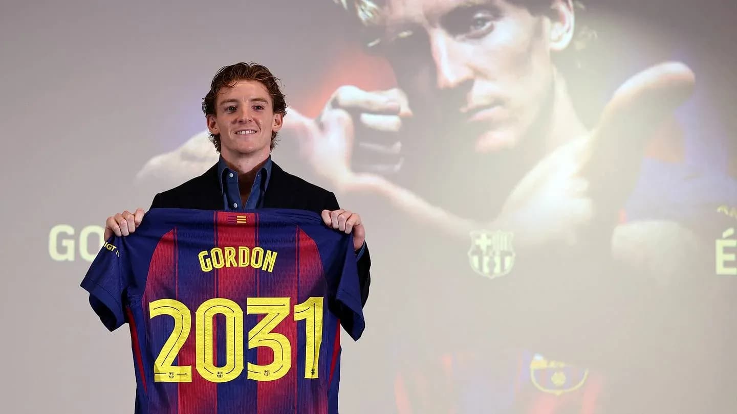 Player holding FC Barcelona jersey with number 2031 Player holding FC Barcelona jersey with number 2031
