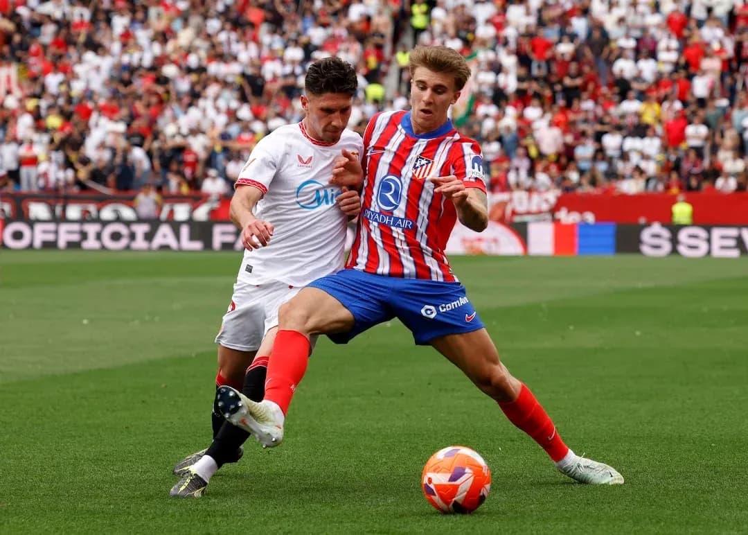 Sevilla and Atletico Madrid players competing for the ball Sevilla and Atletico Madrid players competing for the ball