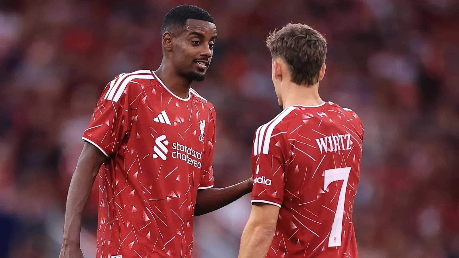 Two Liverpool players discussing during a match Two Liverpool players discussing during a match