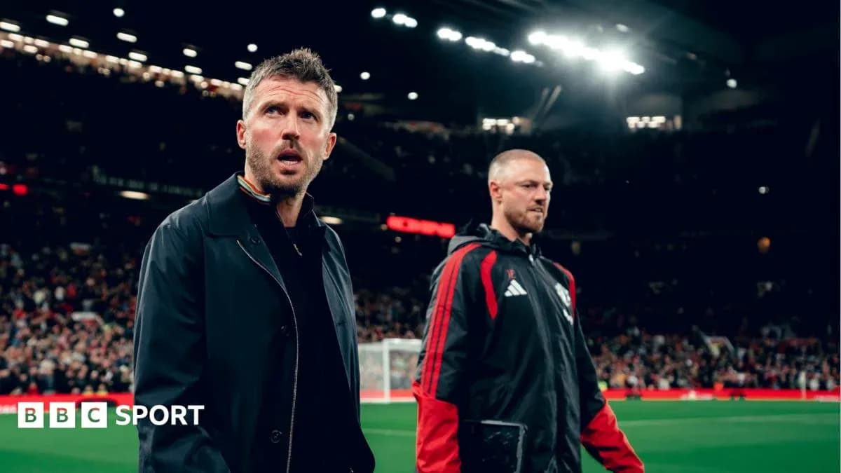Coaches walking on the pitch at Old Trafford Coaches walking on the pitch at Old Trafford