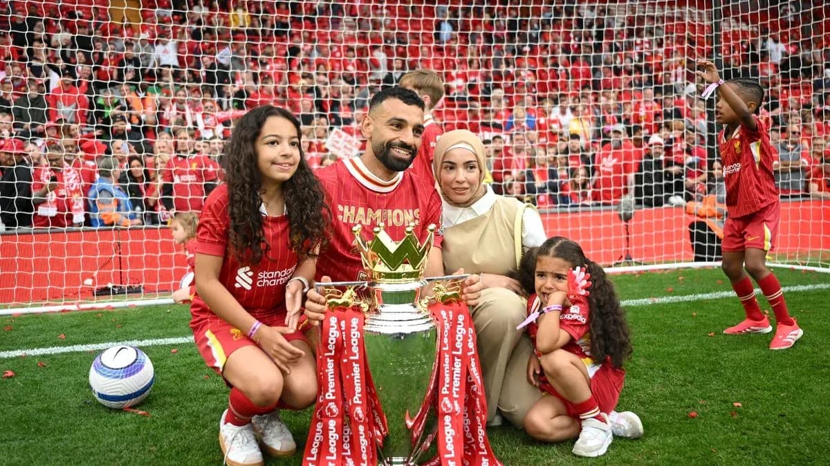 Player celebrating Premier League title with family and trophy Player celebrating Premier League title with family and trophy
