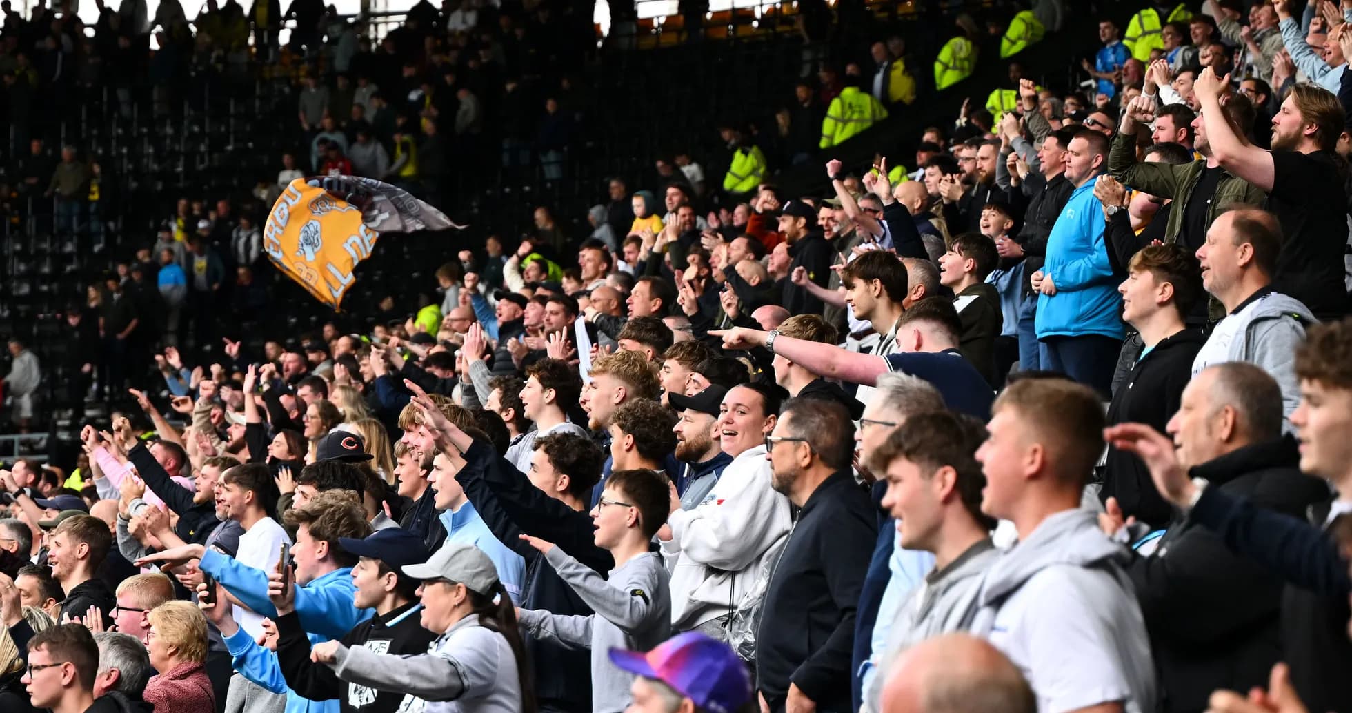 Crowd of fans cheering passionately in stadium Crowd of fans cheering passionately in stadium