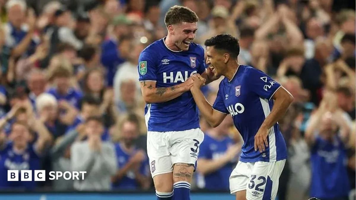 Two Ipswich Town players celebrating a goal Two Ipswich Town players celebrating a goal