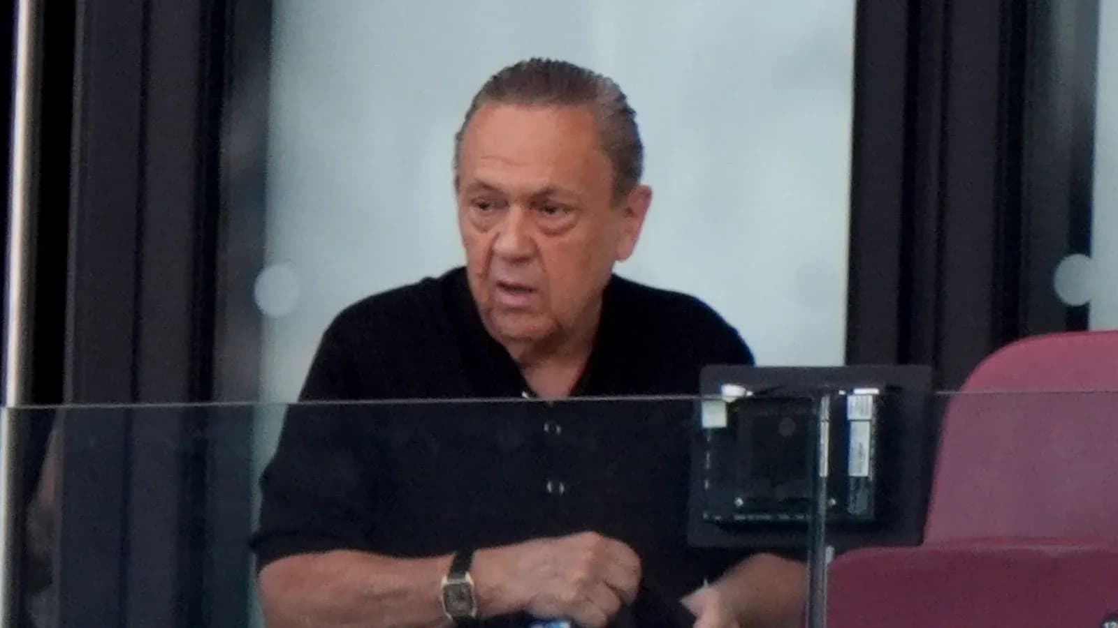 Man observing from a stadium box during event Man observing from a stadium box during event