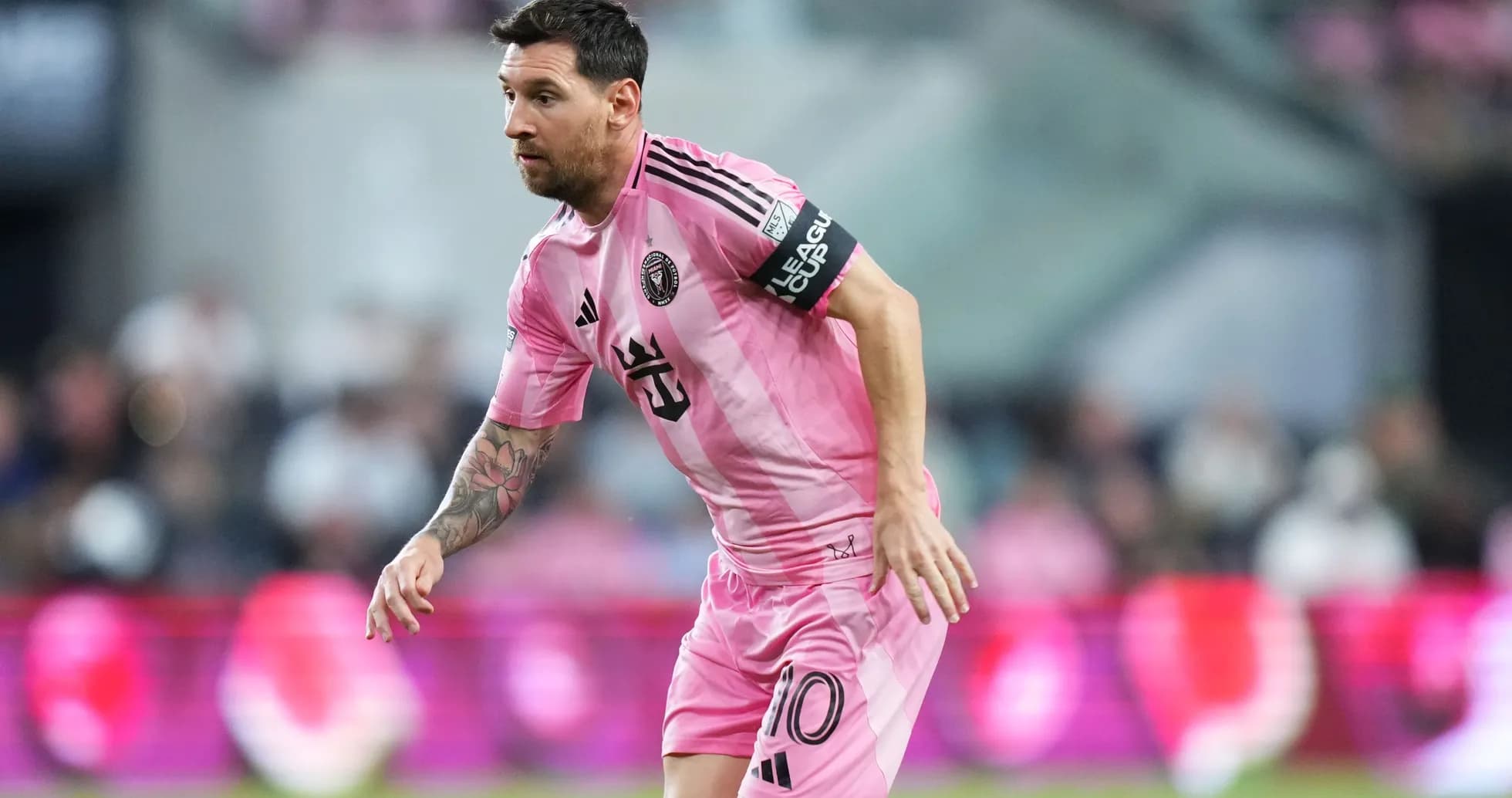 Lionel Messi in pink jersey running on the field Lionel Messi in pink jersey running on the field