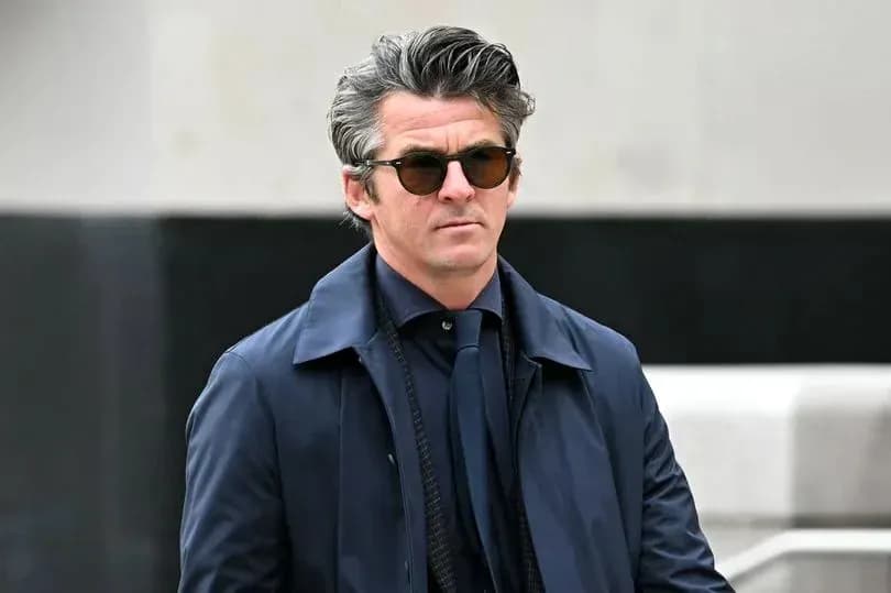 Man in sunglasses wearing a navy coat outdoors Man in sunglasses wearing a navy coat outdoors