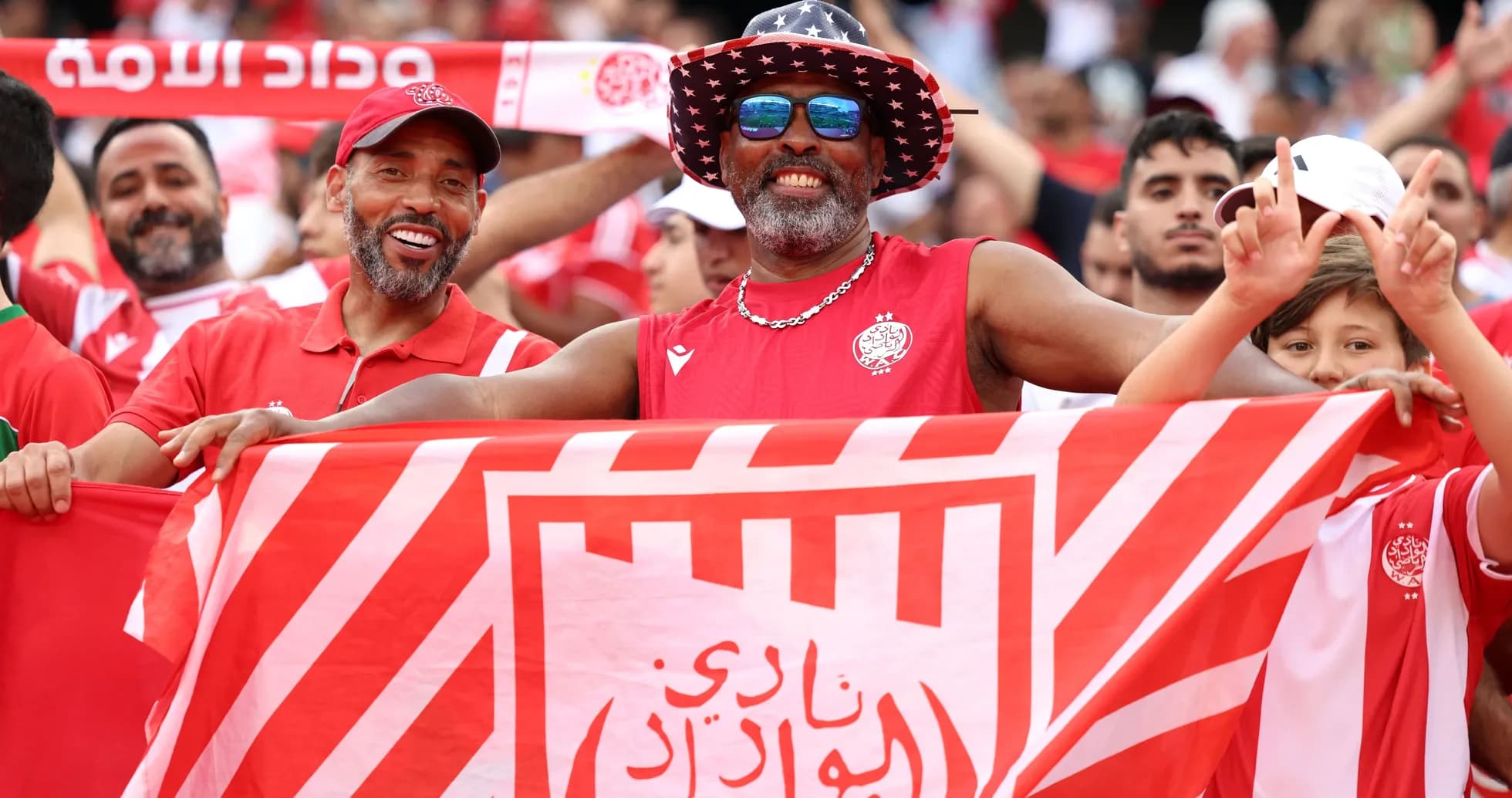 Fans celebrating with flags at a sports event Fans celebrating with flags at a sports event