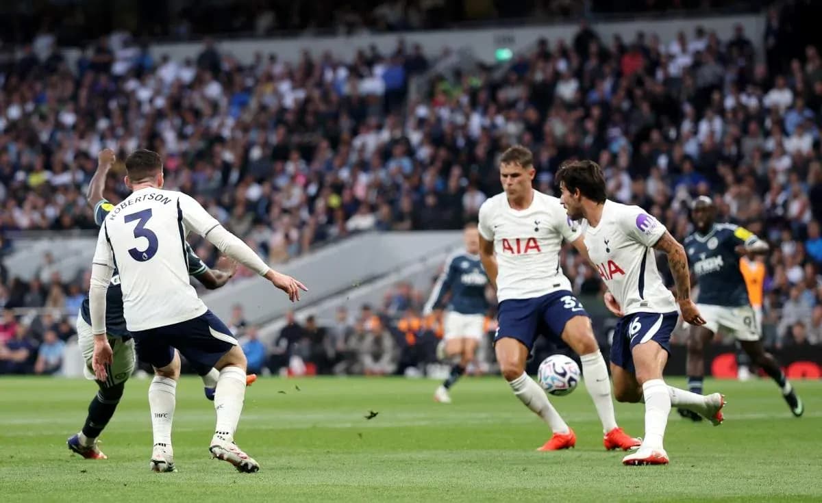 Tottenham players defending against an attacking player Tottenham players defending against an attacking player