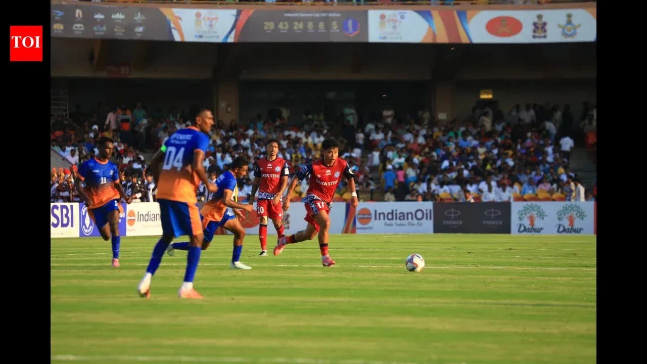 Players competing for the ball during a football match Players competing for the ball during a football match