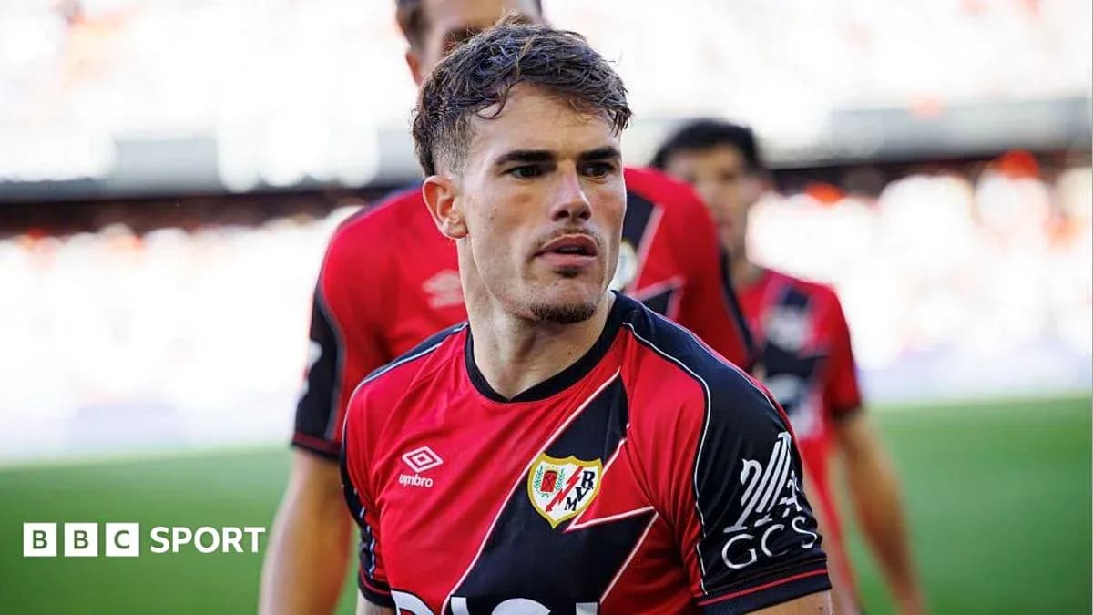 Player in red and black jersey during match Player in red and black jersey during match