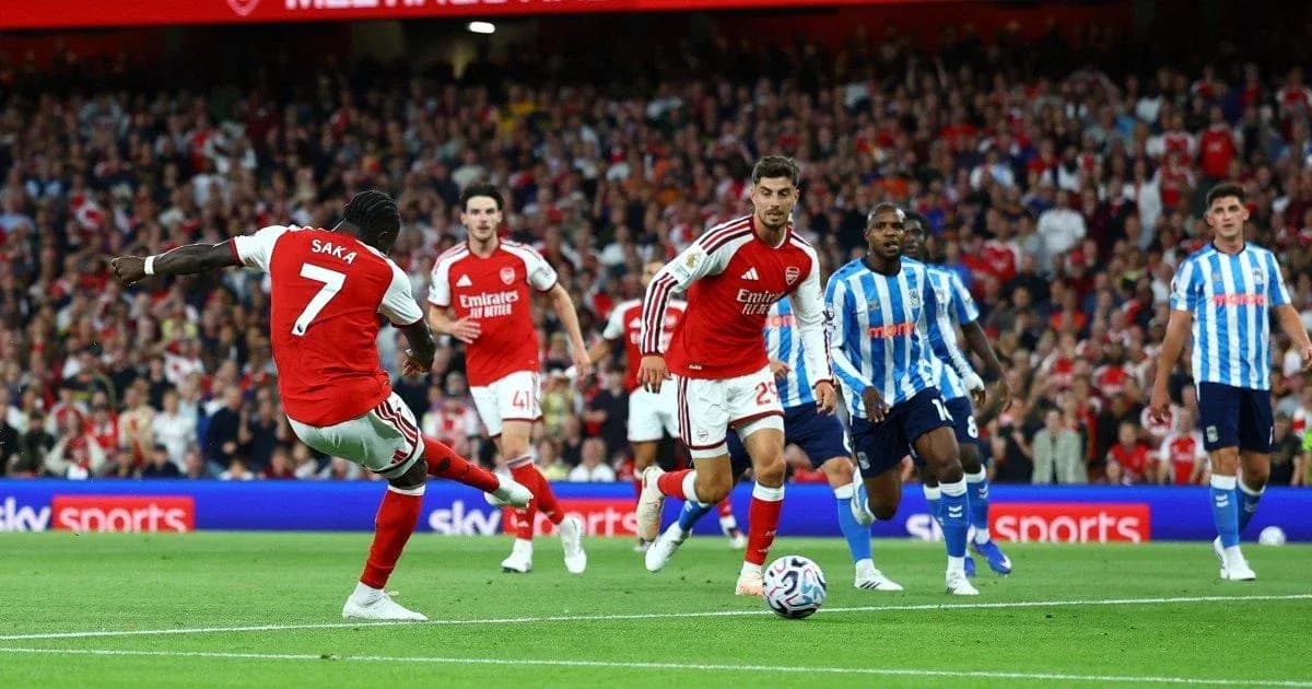Saka shooting the ball during Arsenal match Saka shooting the ball during Arsenal match