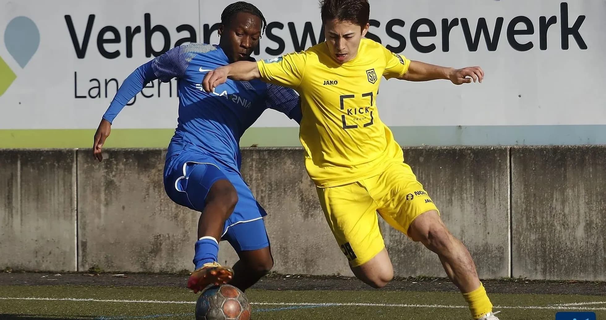 Two players competing for the ball in football Two players competing for the ball in football