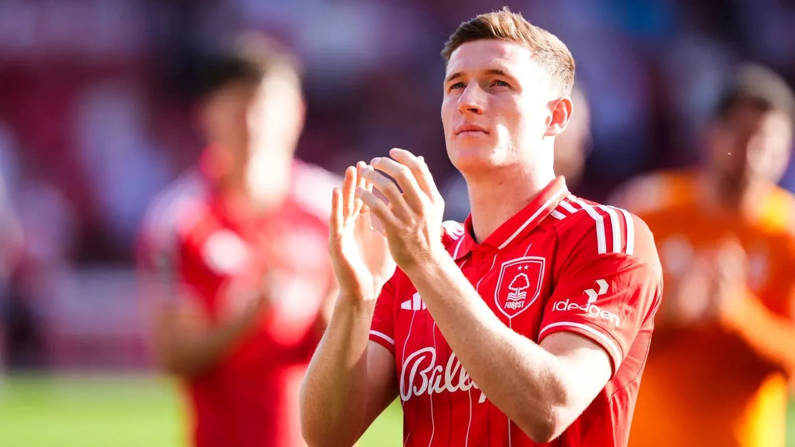 Player applauding fans while wearing red jersey Player applauding fans while wearing red jersey