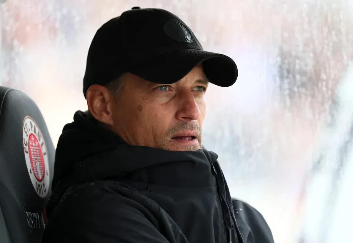 Coach observing from the bench during rainy match Coach observing from the bench during rainy match