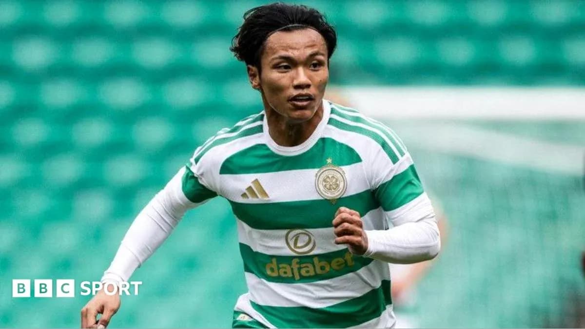 Player in Celtic kit running on the pitch Player in Celtic kit running on the pitch