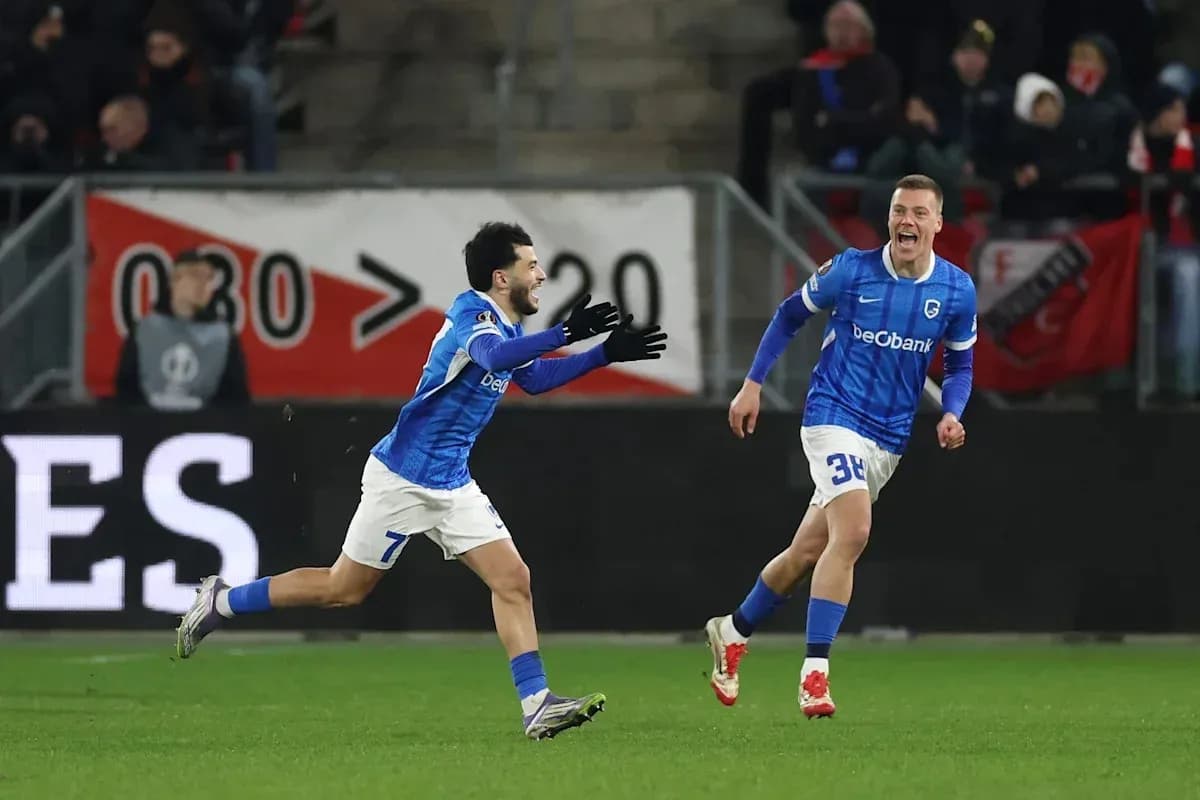 Two players celebrating a goal on the pitch Two players celebrating a goal on the pitch