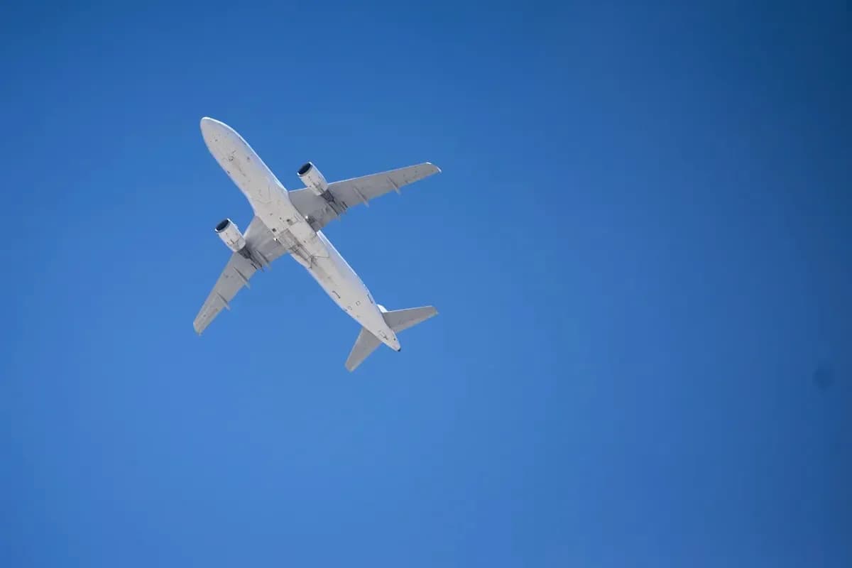 Airplane flying in clear blue sky Airplane flying in clear blue sky